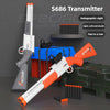 An S686 Transmitter rifle in orange and white is shown next to a box of blue and red items.