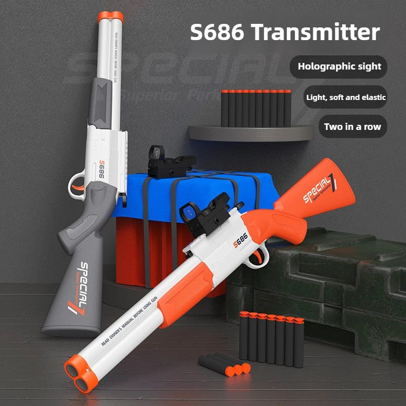 An S686 Transmitter rifle in orange and white is shown next to a box of blue and red items.