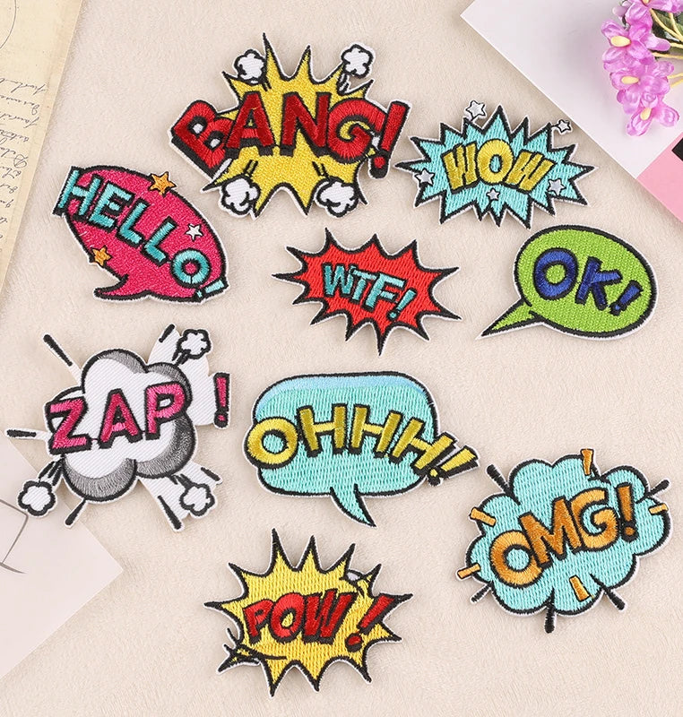 A collection of colorful embroidered lettering patches featuring words like BANG HOW WTF OK ZAP OHH OMG POW