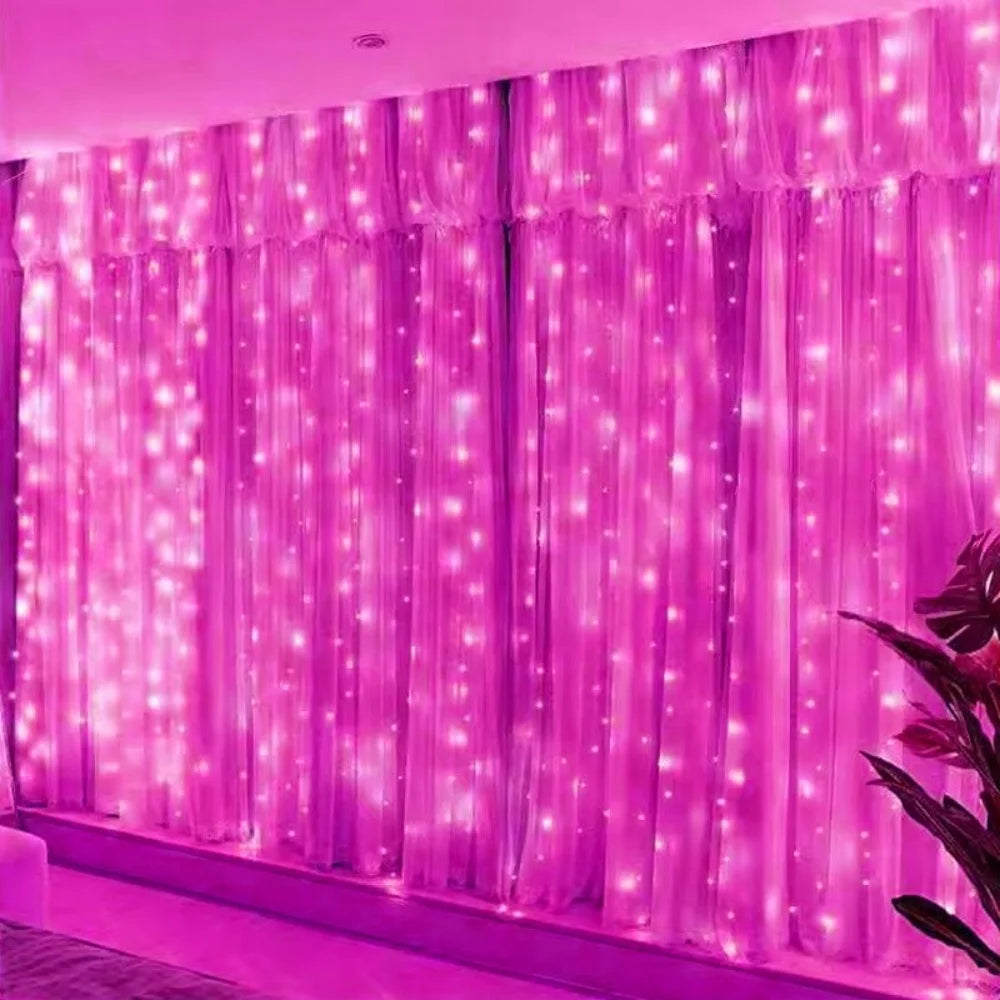 Pink LED curtain string lights with fairy lights illuminating a window or backdrop.