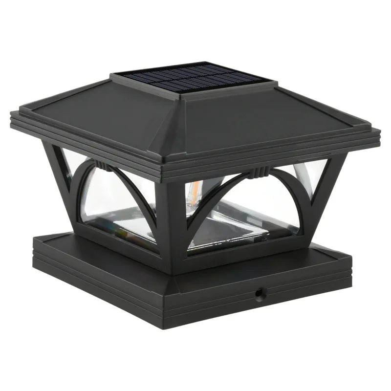A black solar post cap light with a glass enclosure and solar panel, designed for outdoor lighting.