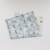 A stack of soft cotton baby pillowcases featuring a repeating pattern of gray and white cartoon pandas on a light blue backgr
