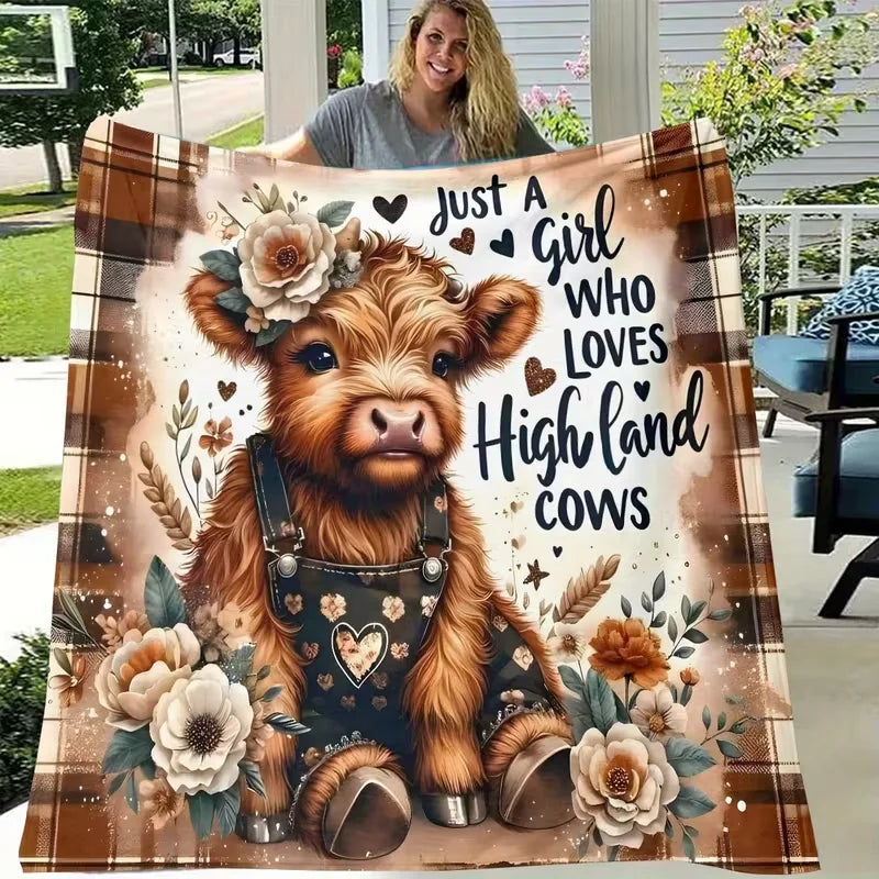 A fluffy Highland cow wearing a leather harness is featured on a flannel blanket design.