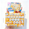 A yellow cartoon keycap fidget keychain with various character designs is shown being held against a white background.