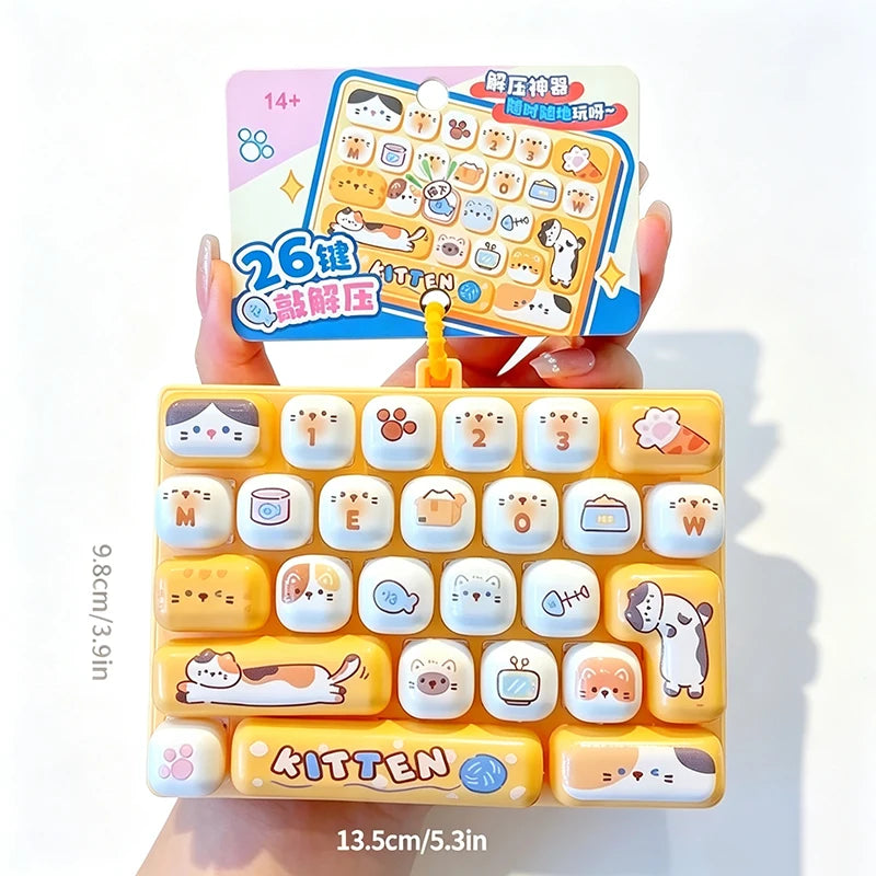 A yellow cartoon keycap fidget keychain with various character designs is shown being held against a white background.