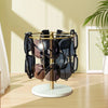 A gold-toned stand with a wooden base organizes twelve pairs of sunglasses in a display setting.