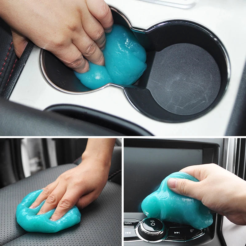 A hand is applying a reusable turquoise cleaning gel to the interior of a car, likely for electronics or surfaces.