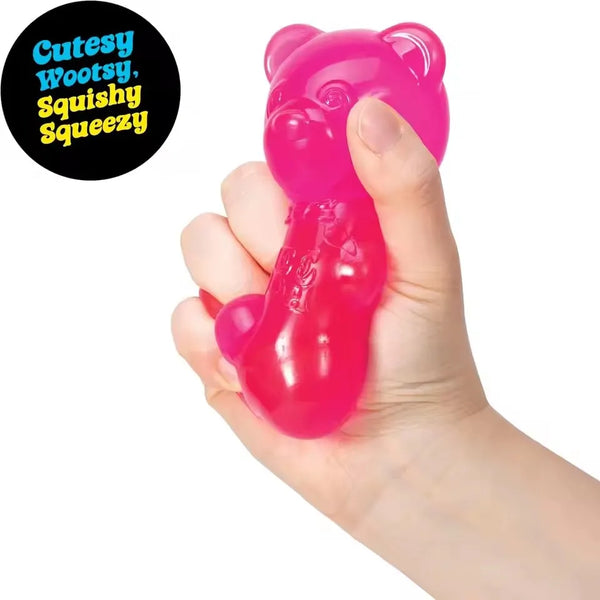 A hand is squeezing a bright pink squishy bear stress relief toy.