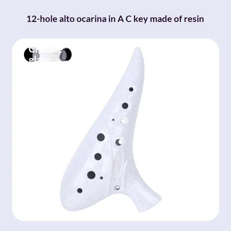 A white resin alto ocarina in the shape of a bird, featuring 12 holes.