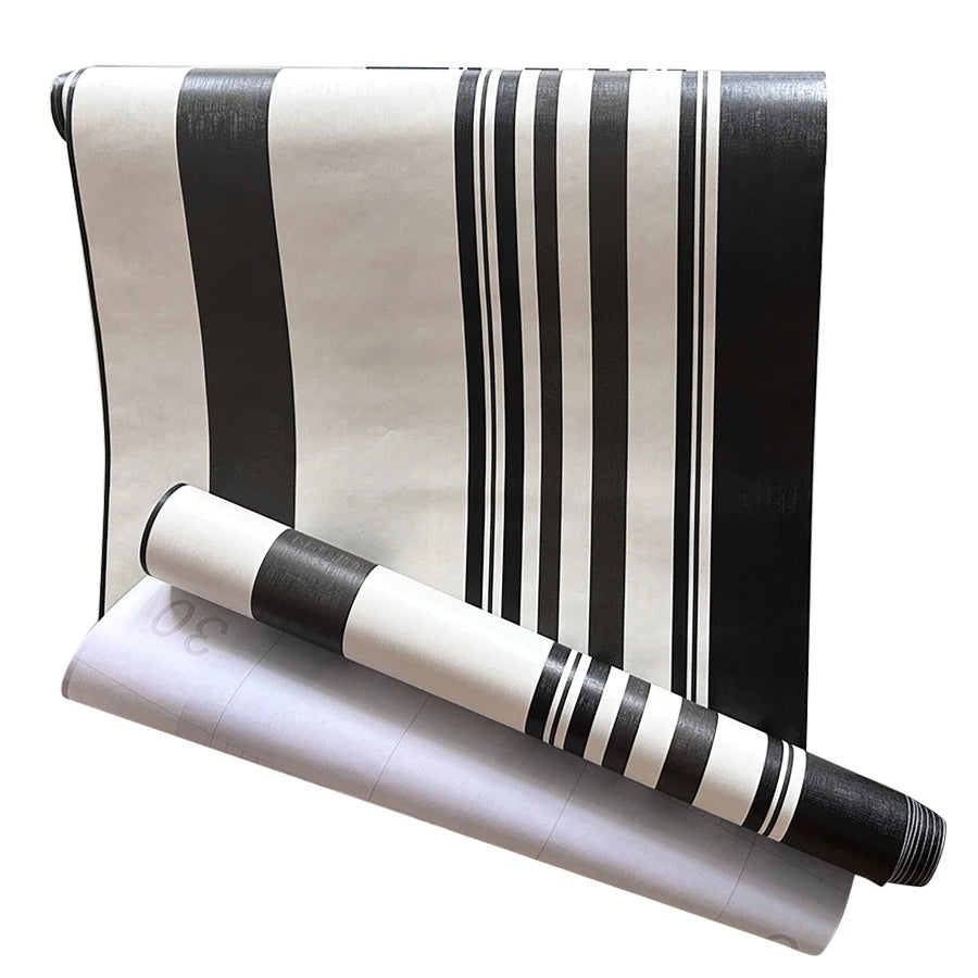 A roll of black and white striped self-adhesive wallpaper.