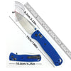 A blue folding pocket knife with a drop point blade shown next to a ruler and measurements.