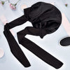 Black satin sleep cap for hair protection shown lying on a light blue surface.