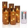 A set of amber glass candles with twinkling string lights and a remote control for lighting.