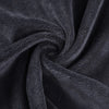 A dark gray microfiber bath towel is tightly rolled, showing its soft texture and absorbency.