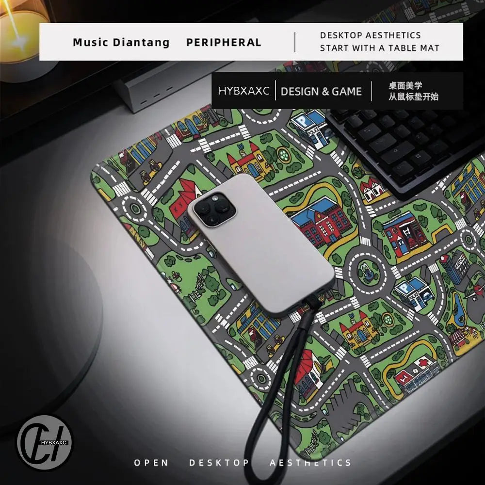 A white smartphone rests on a green and gray city road design mouse pad next to a laptop.