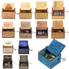 A collection of hand-cranked wooden music boxes featuring various themes like You Are My Sunshine and Merry Christmas.
