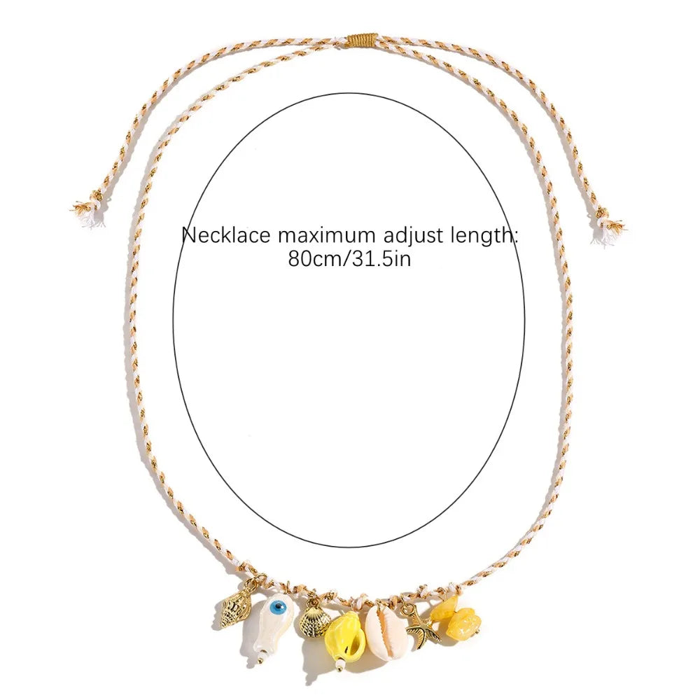 A gold-colored beaded necklace with a circular pendant featuring cute cartoon fish charms.