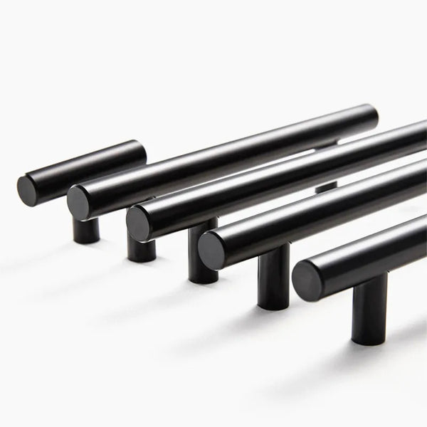 A set of black stainless steel T-bar cabinet pull handles arranged diagonally.