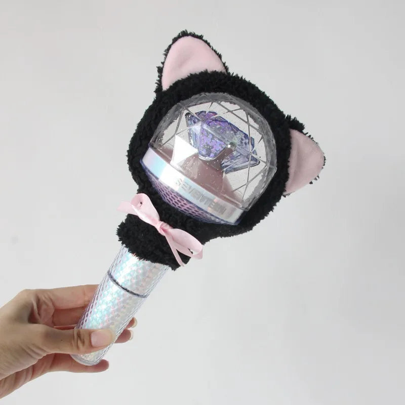A black plush cover with pink ears and a clear dome featuring a purple light stick inside.