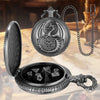 A silver dragon-themed pocket watch and dice case with a chain, featuring metal polyhedral dice inside.