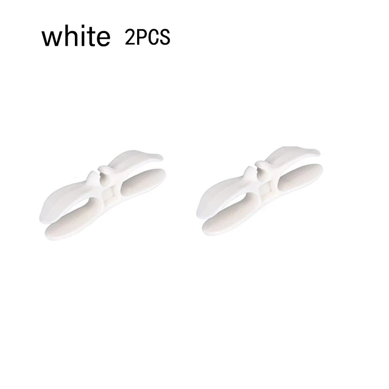 Two white cord organizers or wire winders for tidy cable management.
