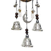 A hanging wind chime made of silver bells and beads used as a witch bells door hanger.