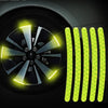 Yellow reflective strips installed on a car wheel rim for enhanced visibility.