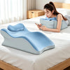 A young woman is using a light blue ergonomic memory foam wedge pillow with a detachable head rest while lying on a bed.