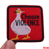 Red embroidered patch featuring a white bird with a black beak and the text Choose VIOLENCE.