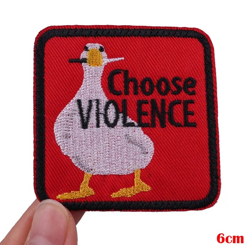 Red embroidered patch featuring a white bird with a black beak and the text Choose VIOLENCE.