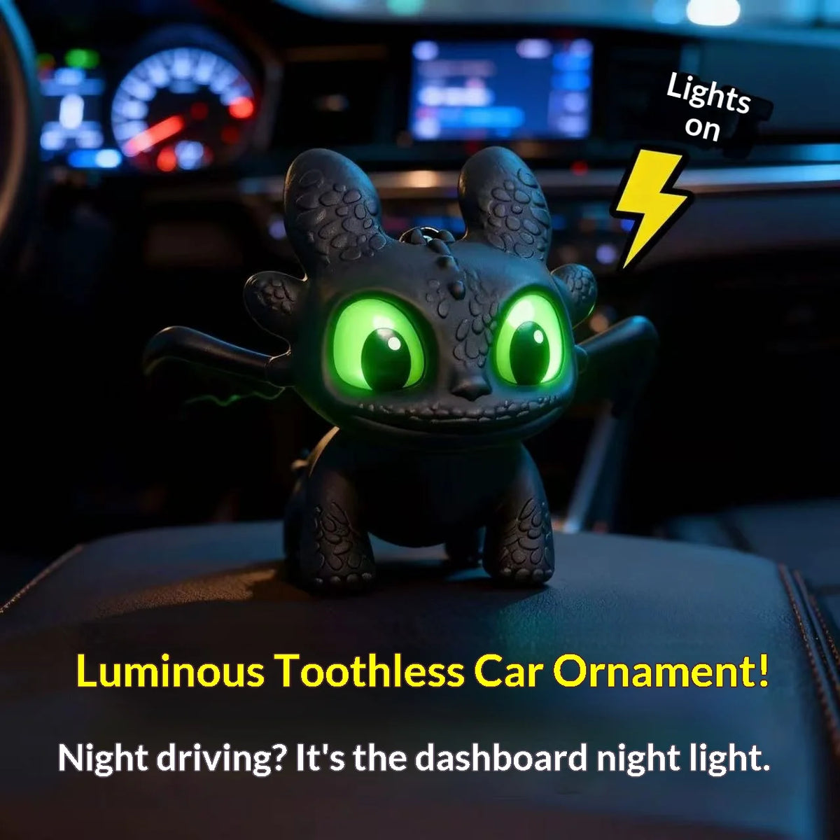A black Toothless car ornament with glowing green eyes and movable wings displayed on a car dashboard.