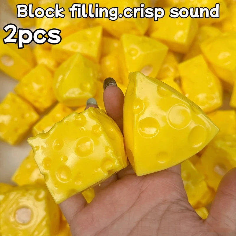 Two yellow block filling fidget cubes are held in a hand.