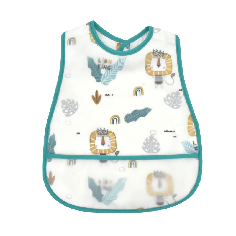 White baby feeding bib with a green trim featuring a lion crown design and decorative leaves