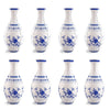 A set of white ceramic puzzle vases with blue floral patterns and spouts.