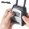 A hand holds a black portable combination key safe with a silver keypad and metal body.