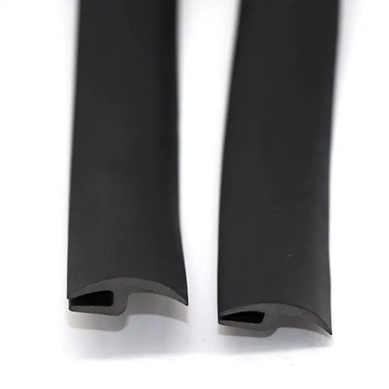 A close-up view of a black flexible rubber windshield seal strip.