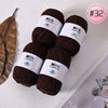 Three skeins of dark brown Milk Cotton yarn with white labels are displayed on a white surface.