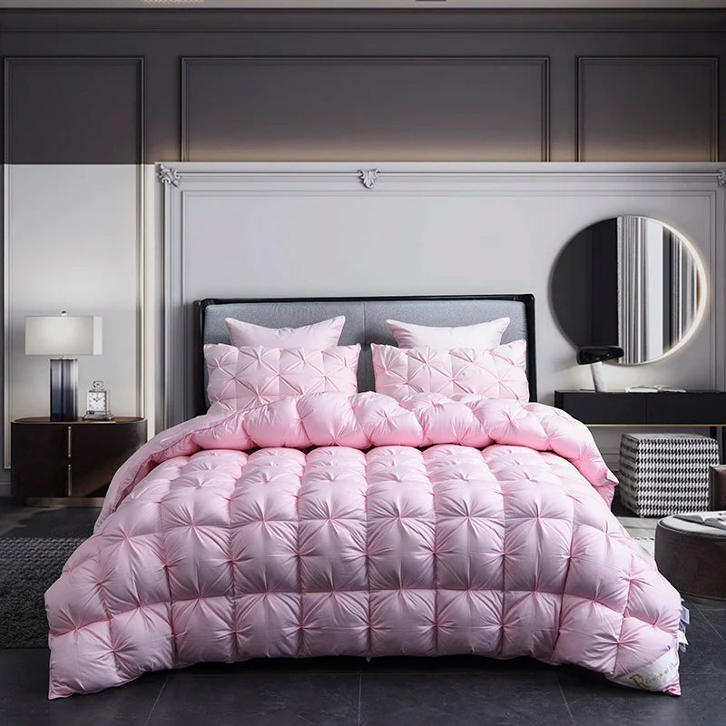 A pink quilted duvet and cover displayed on a bed with a gray upholstered headboard.