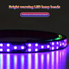 A close-up of a bright warning LED lamp bead light bar illuminating a surface with vibrant purple light.