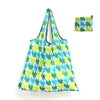 A reusable shopping tote bag featuring a green and yellow patterned fabric, shown with an attached carry pouch.
