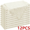 A stack of six raw-edge, light beige polyester cloth napkins.