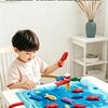 A child is playing with a fabric fishing game featuring colorful fish on a blue mat.