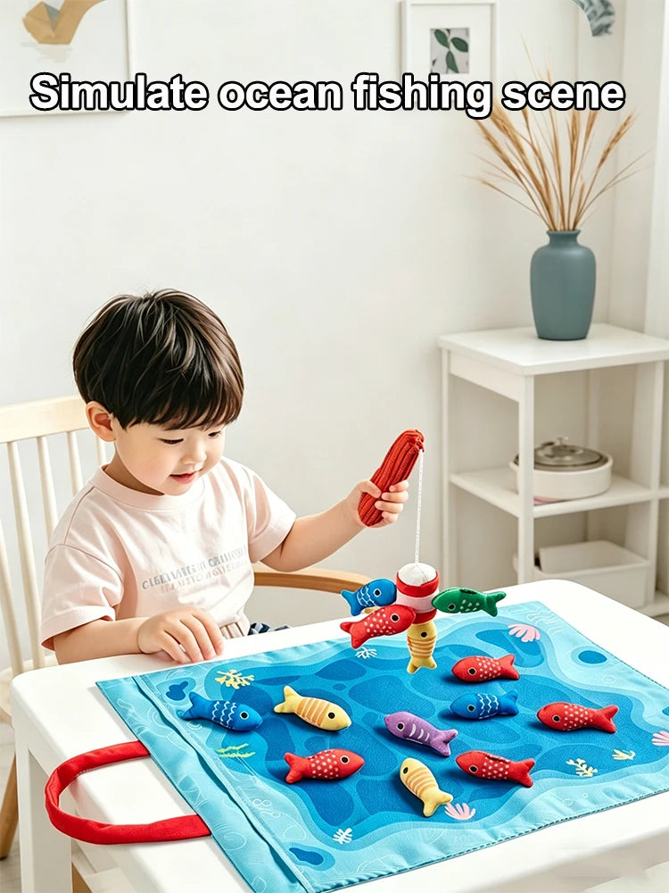 A child is playing with a fabric fishing game featuring colorful fish on a blue mat.
