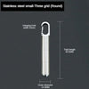 A stainless steel small three grid round hanging hole pill capsule with a keychain.