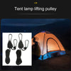 A tent lamp lifting pulley system with hooks and ropes shown next to an open tent in a dark outdoor setting.