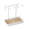 A white jewelry display rack featuring a drawer and a wooden base with multiple hanging arms.