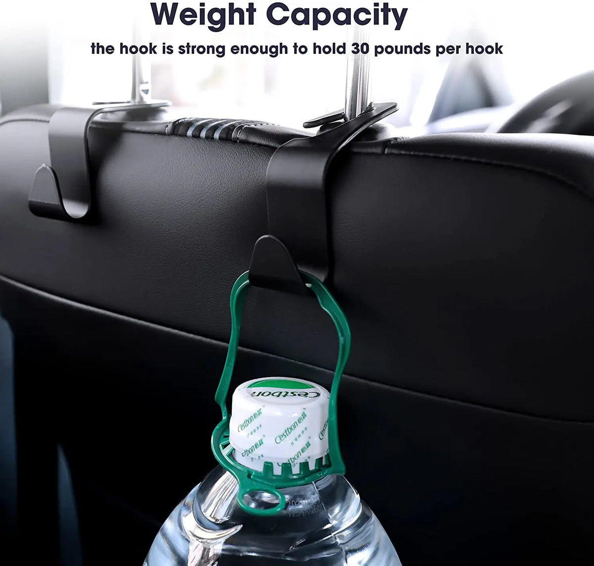 A green car seat headrest hook is shown holding a plastic water bottle.