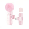 A pink USB-C wireless lavalier microphone with a fluffy pink foam cover and a clip attachment.