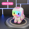 A white interactive robot with pink accents and a multicolored light visor standing on a circular platform.