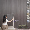 A person is applying an extra thick 3D wood grain self-adhesive foam wall panel to a gray wall.